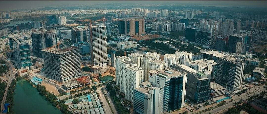 Aerial view of Hyderabad Real Estate with IT offices, high-rise apartments, and growing infrastructure.